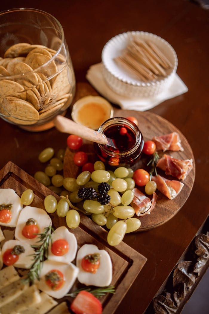 Home Close-up of a charcuterie board featuring cheeses, meats, fruits, and crackers, perfect for events and gatherings.
