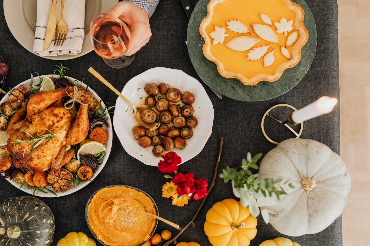 The Art of Drawing Readers In: Your attractive post title goes here A top-down view of a festive autumn dinner featuring roast chicken, pumpkin pie, and various side dishes.